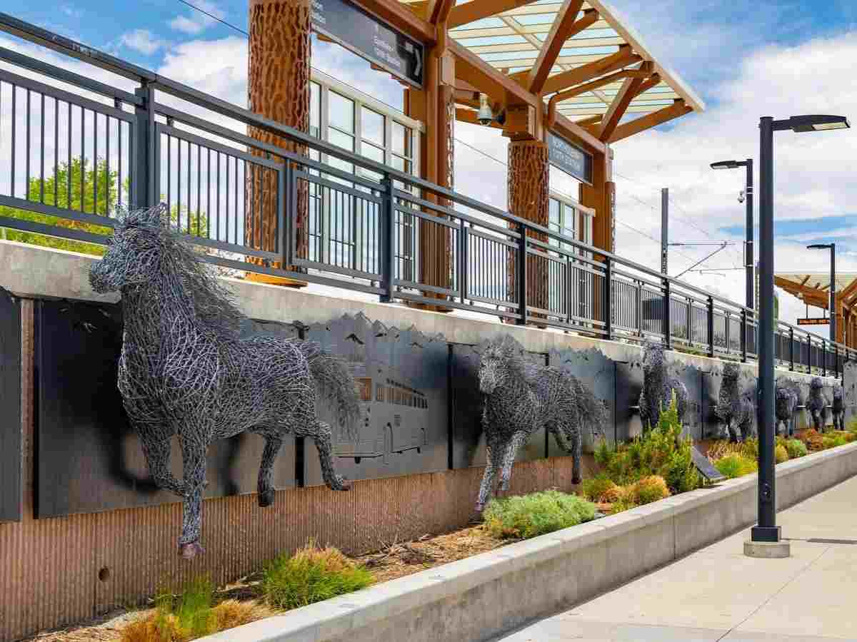 Light Rail station with wire horse sculptures running along side it for article Northglenn Colorado for newcomers moving to Denver area.