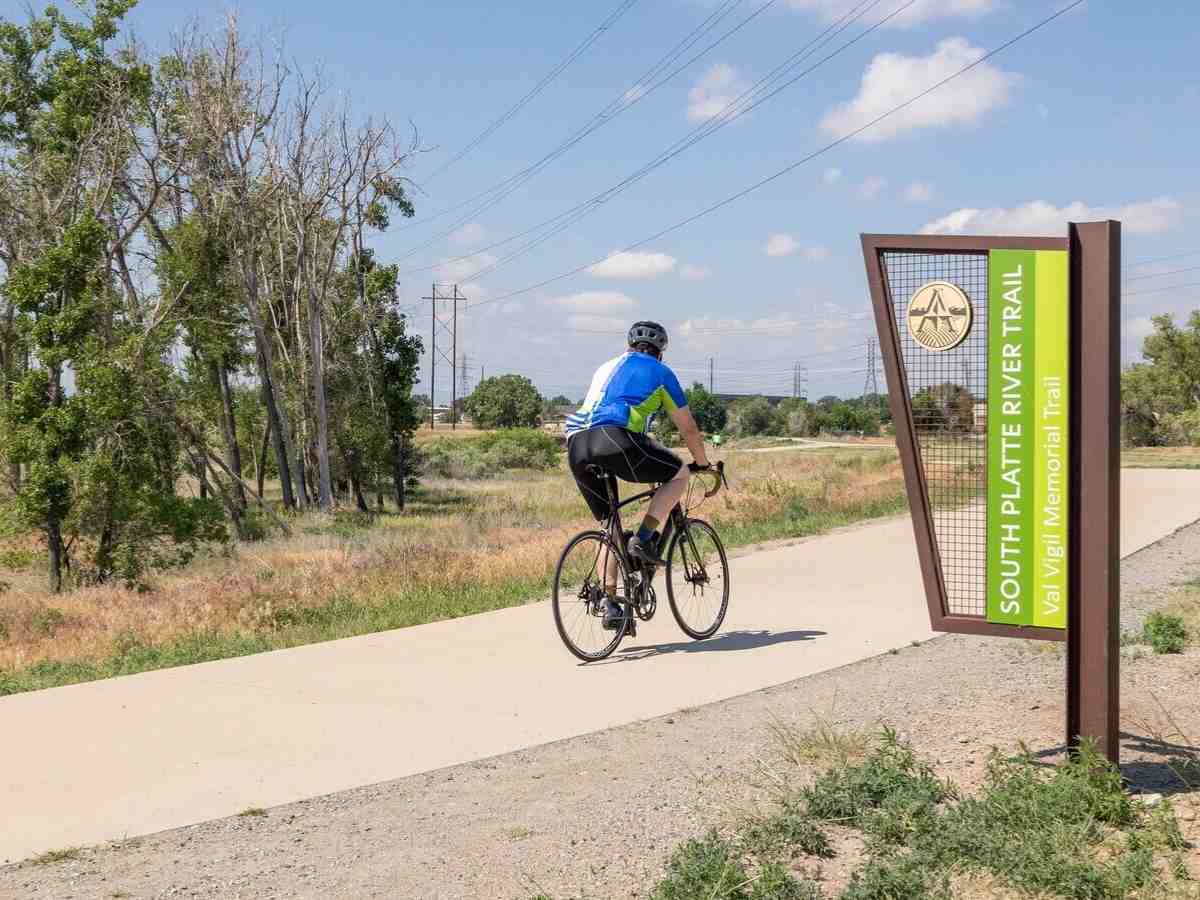 Person riding their bike on South Platt River Trail for article Thornton Colorado for newcomers moving to Denver area.