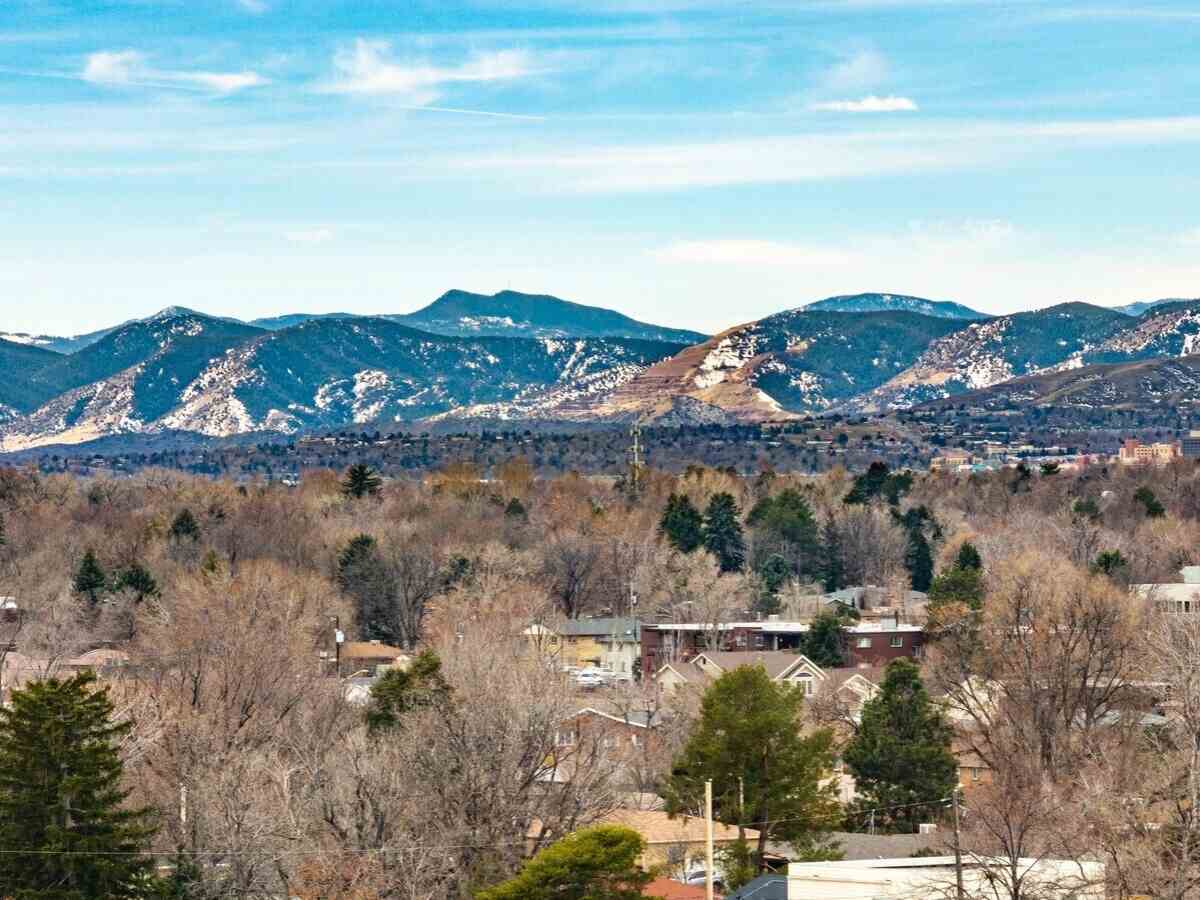 Aerial view of homes with mountains in the background for article Wheat Ridge Colorado for newcomers moving to the Denver area.