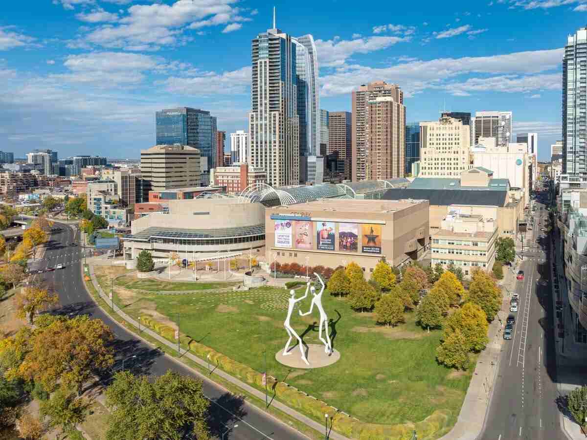 Downtown Denver with sculpture park in the foreground and high rise apartment and business buildings in the background for article Denver Rentals: Why So Many Newcomers Are Making the Move.