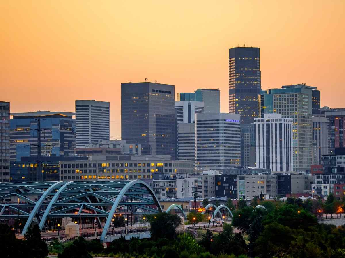 Denver skyline with orange sky for article High-Paying Jobs in Denver for newcomers moving to Denver.