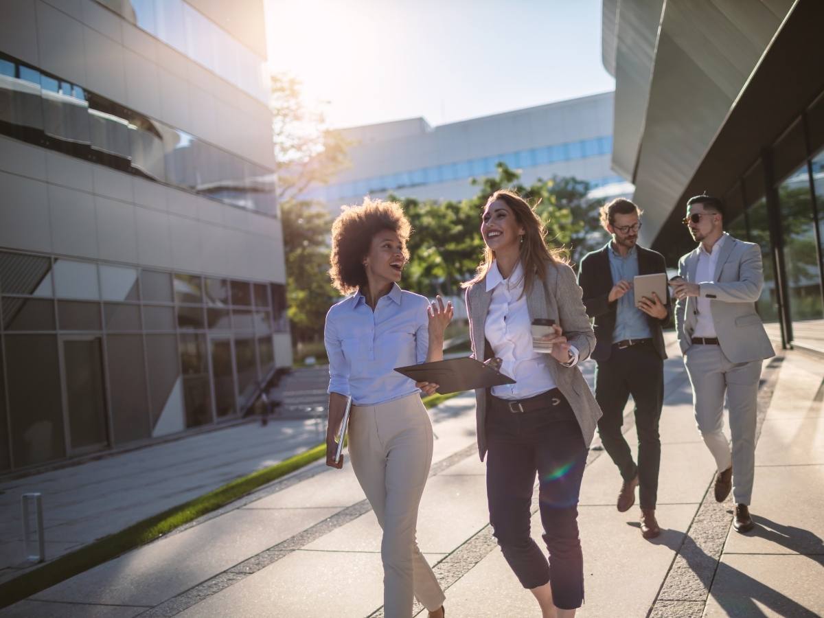 4 young professionals walking outside down street for article Best Neighborhoods in Denver for Young Professionals in 2025 for newcomers moving to Denver area.