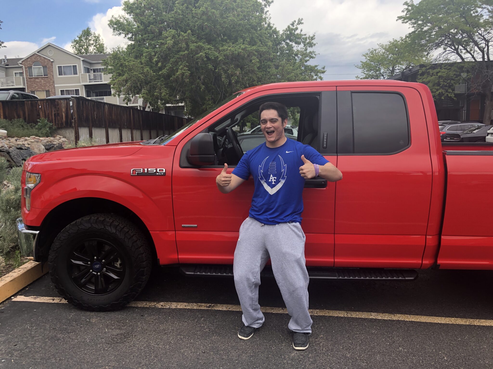 A boy and his red Ford Truck