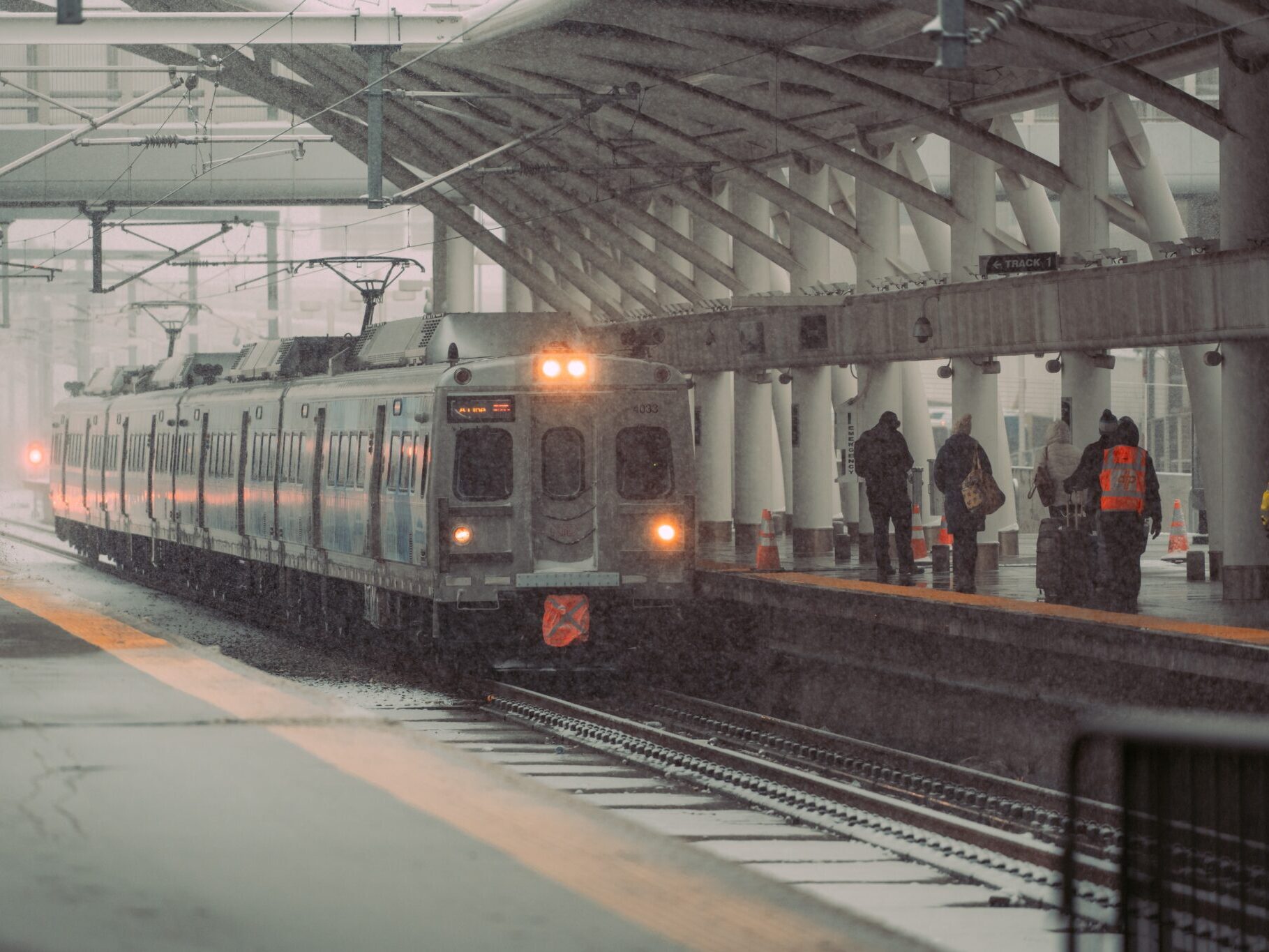 Commuter train pulling into the station in the snow