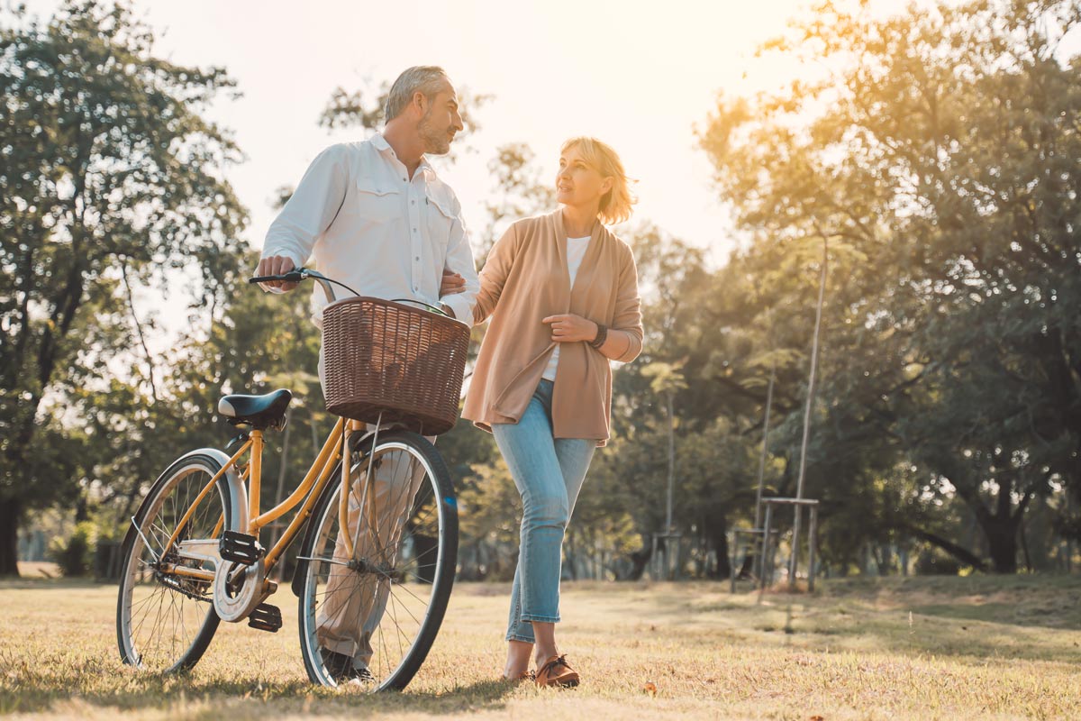 Department Image: BE WELL. Mature couple walking on trails.