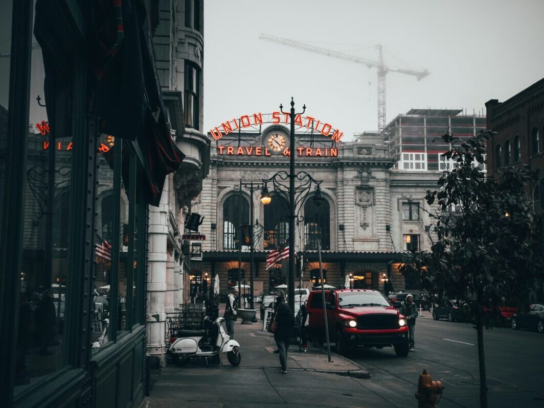 People walking the streets of downtown Denver on a foggy, freezing cold day.