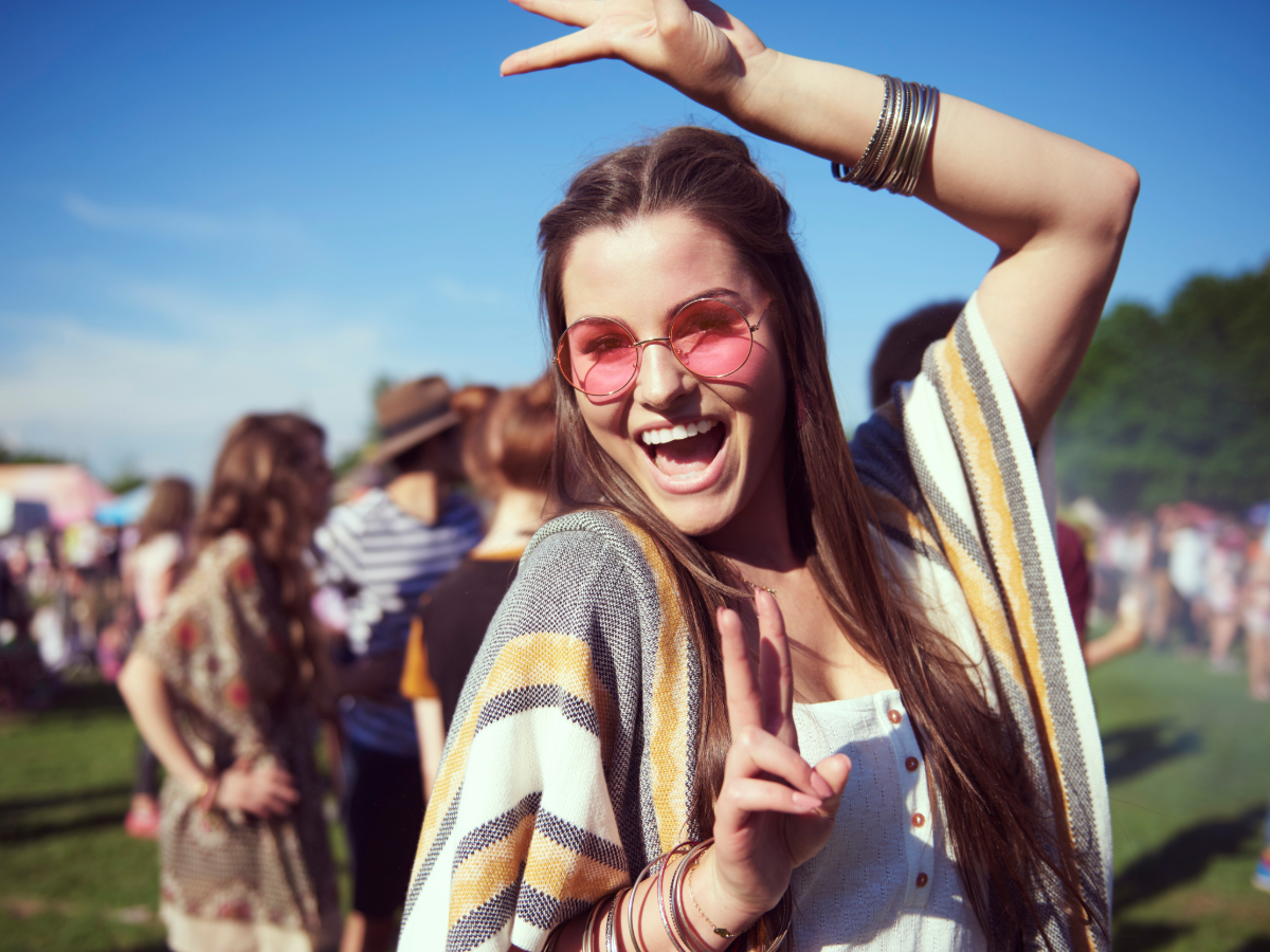 Girl dancing at outdoor festival.