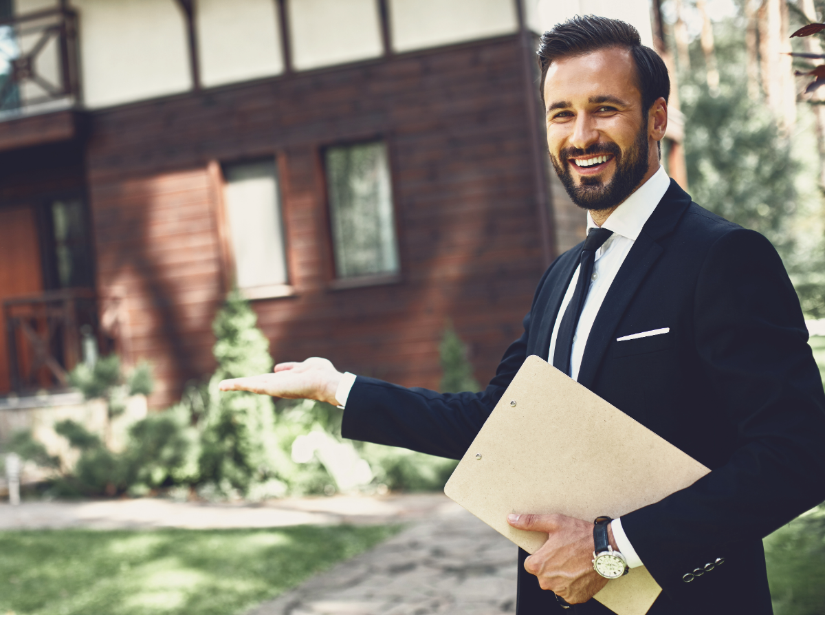 Real estate agent holding folder standing in front of house.