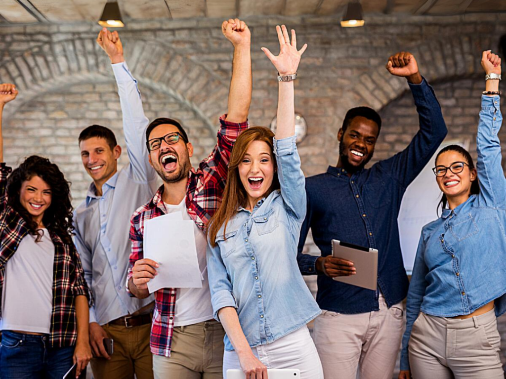 Coworkers cheering and reaching arms up.