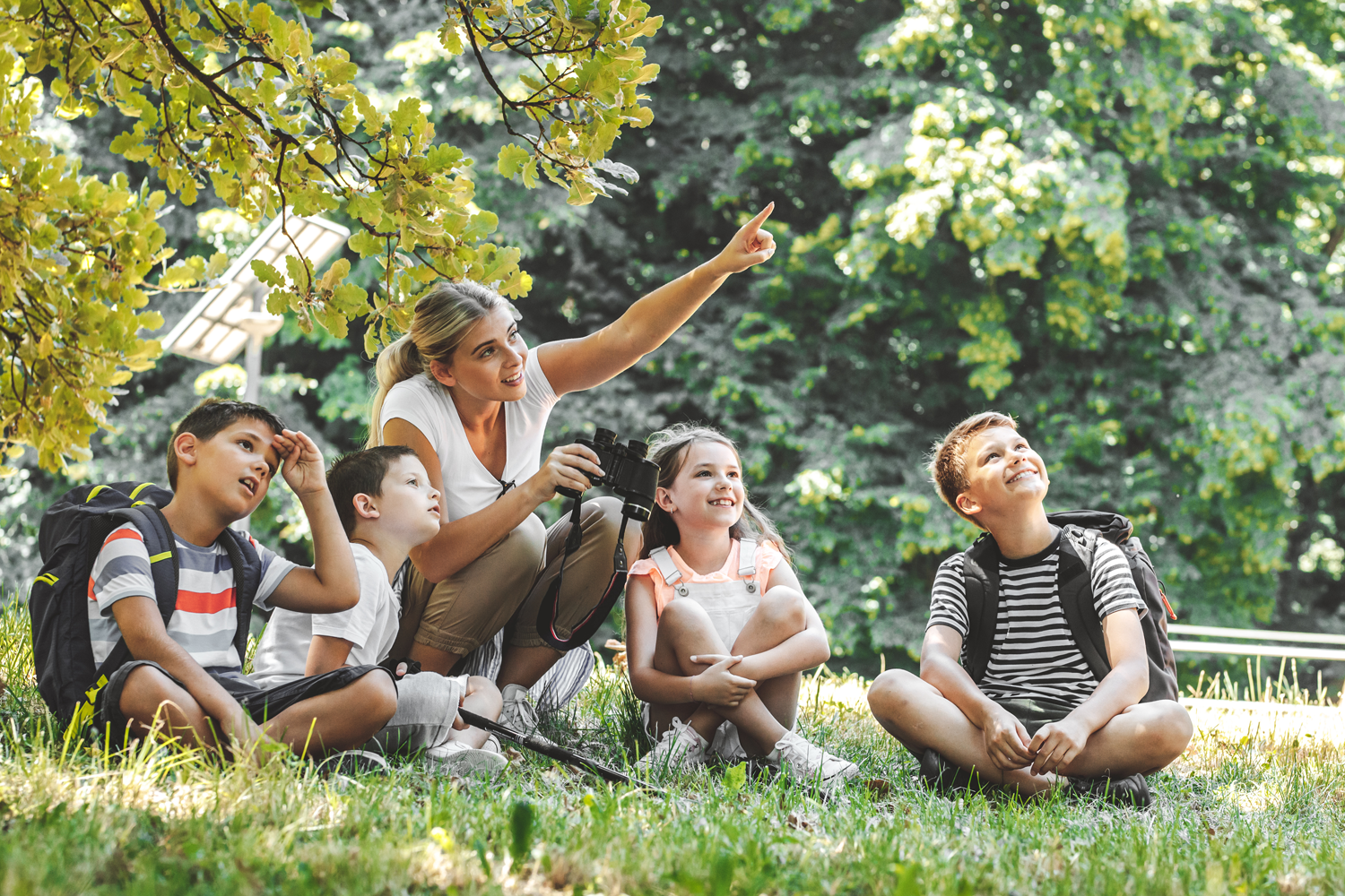 Department Image: LEARN. Teacher in nature with a group of students