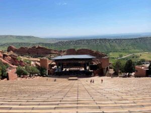 Looking down at the stage from top center seats at Red Rocks during the day for article Concerts at Red Rocks in 2025 for newcomers moving to Denver.