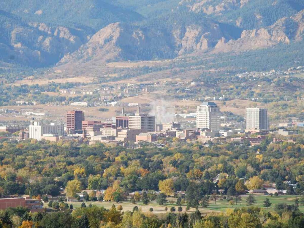 Aerial view of downtown Colorado Springs with mountains in the background for article Top Private Employers in Colorado Springs for newcomers moving to Colorado Springs.