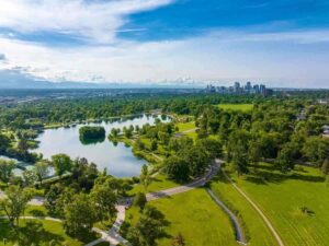 Aerial view of Washington Park with Denver Skyline in the distance for article Why Move to Denver? for newcomers moving to the Denver area.