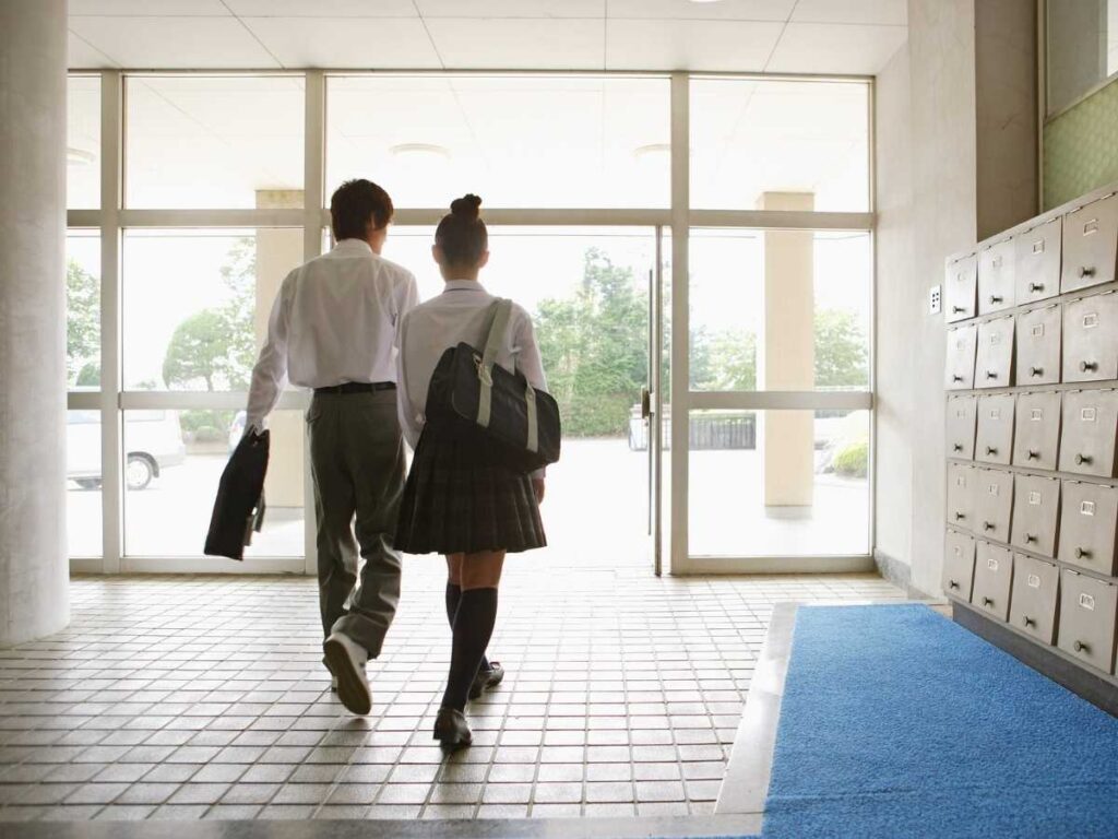 Boy and Girl in private school uniforms walking out of a school for article Top Private Schools in Denver (2025) for newcomers moving to Denver.