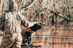Hunting and FIshing in Colorado - man with dog bird hunting