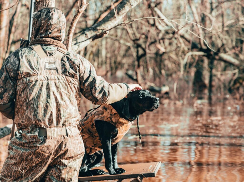 Hunting and FIshing in Colorado - man with dog bird hunting
