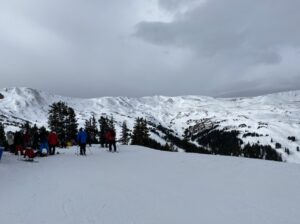 Skiers on a mountain top - COlorado ski resorts