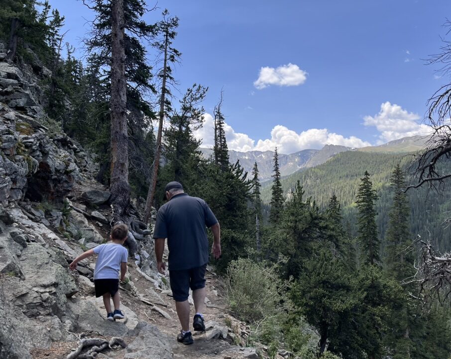 Moving to denver in 2026 Man and child hiking in Echo Lake